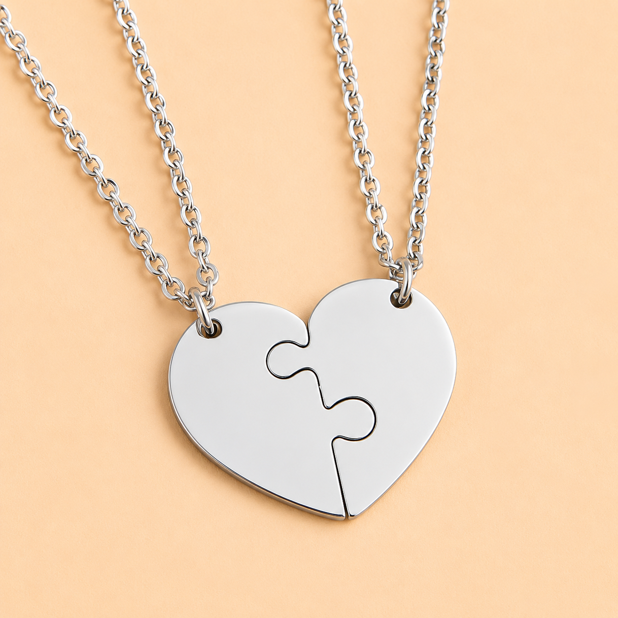 Close-up view of stainless steel heart puzzle pendants that fit together perfectly.
