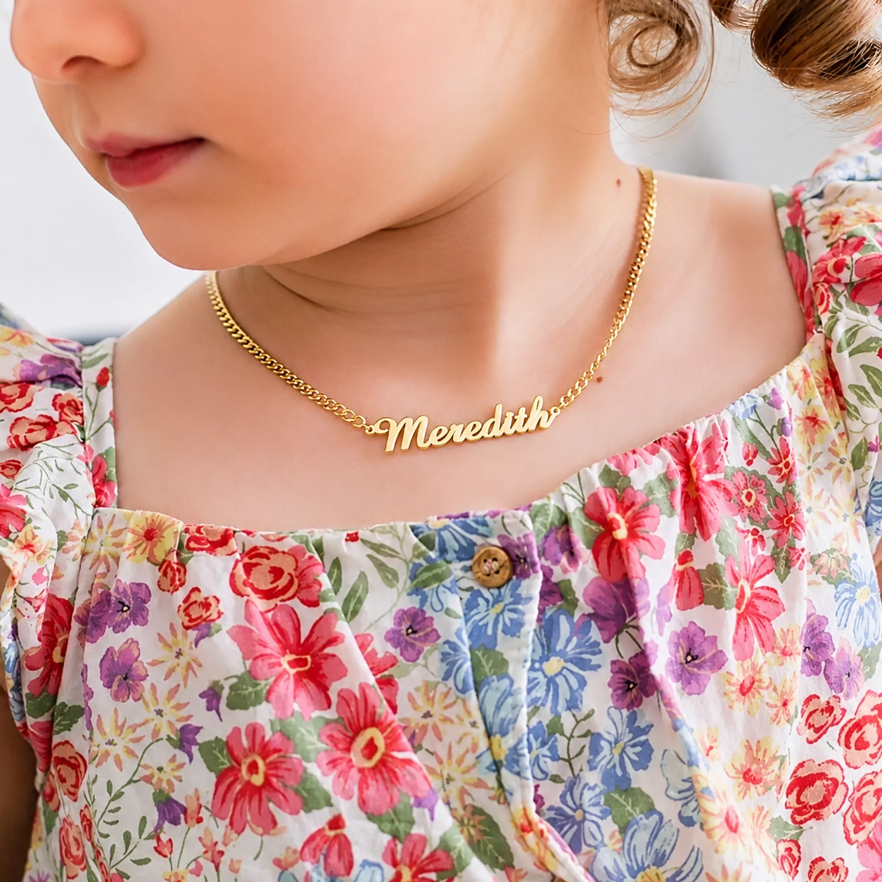 Close up of personalized kids nameplate necklace engraving