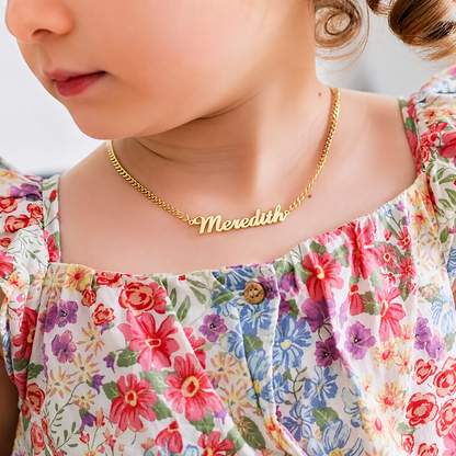 Close up of personalized kids nameplate necklace engraving